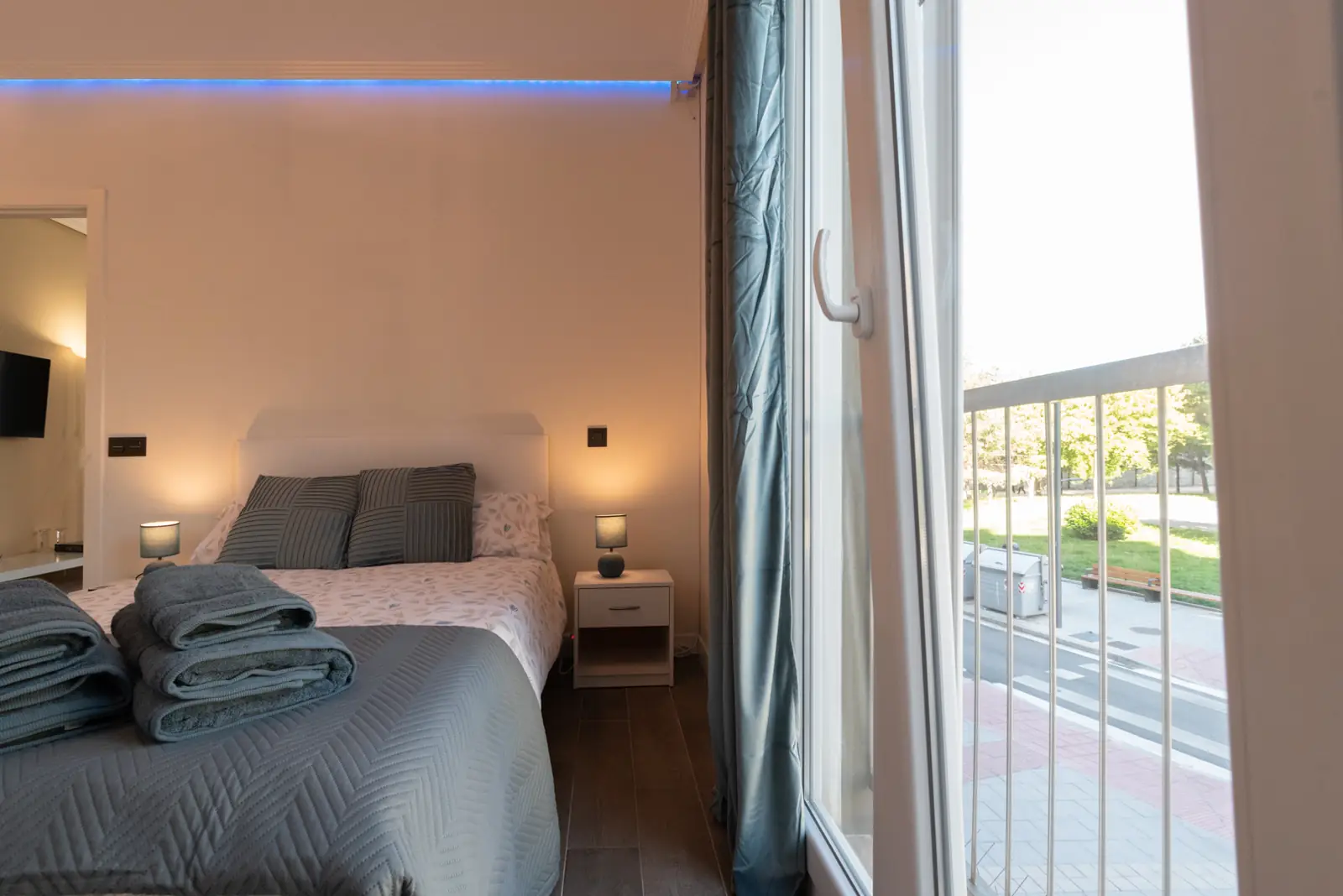 Bedroom with a 150 cm queen bed and a window with blackout curtains